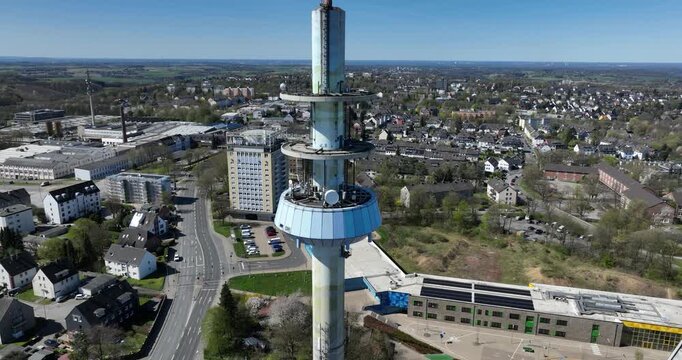 Close-up aerial view of the Telebert broadcasting antenna rising above Velbert, Germany
