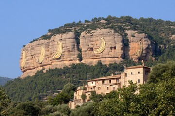 Banana-shaped murals on a mountaintop overlooking a village