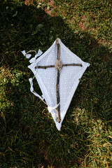 kite on green grass and religious symbol