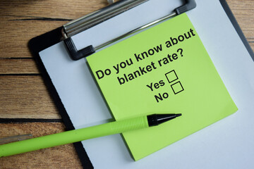 Do you know about blanket rate write on sticky notes isolated on Wooden Table. A person is answering question concept