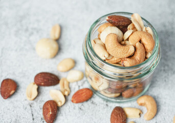 Close up of Healthy mix nuts in a bowl. Almonds, hazelnuts, cashews, peanuts, pistachios and macadamia.