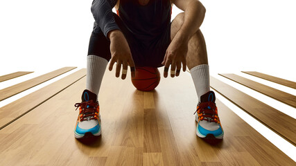 Front view of basketball player sitting with ball between legs on court. Concept of body recovery, sports branding, editorial visuals, mental readiness, athlete's lifestyle promotion.