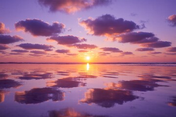 Obraz premium Dramatic orange and red sunset over the tranquil sea with clouds and sunlight on the horizon 
