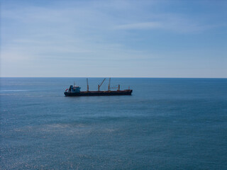 Cargo ship with cranes at sea