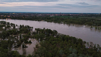 Aerial view of the flooded Po River submerging fields, trees and houses in the countryside between Emilia Romagna and Lombardy after intense spring rainfall