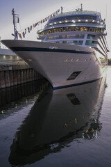 Fototapeta premium All inclusive luxury yacht cruiseship cruise ship liner Star docked in port St. Lawrence River in Montreal, Quebec Canada during New England Indian Summer cruising