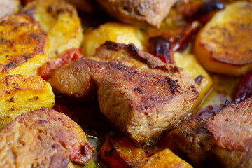 roasted pork with potatoes and carrots in tray