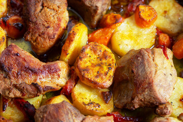 roasted pork with potatoes and carrots in tray