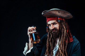 Charismatic Pirate Holding Rum Bottle in Studio Portrait on Black Background