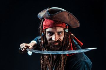 Intense Pirate with Sword and Tricorn Hat in Studio Portrait on Black Background