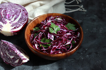 Shredded purple cabbage in a wooden bowl for salad