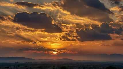 Fototapeta premium Golden Hour Spectacle Radiant Sunbeams Burst Through Fluffy Clouds at Sunset, Casting a Warm Glow Over Rolling Hills