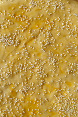 close-up of egg-washed scone dough with sesame seeds