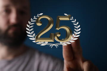 Image of a man showcasing the number 25 within a laurel wreath, symbolizing a 25th anniversary or...
