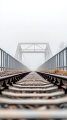 Fototapeta premium Ethereal railway bridge emerges from dense fog, a mysterious path into the unknown