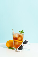 Summer cold drink on colored background with hard shadows.
