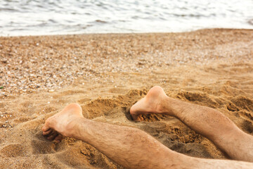 man relaxing on the beach. Vacation and weekend