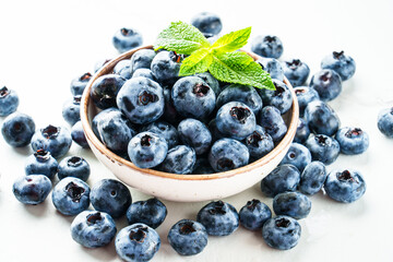 Blueberries in the bowl on white.