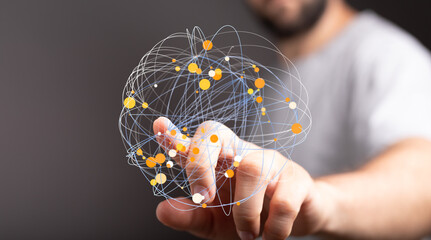 Hand interacting with a digital network sphere.  Represents connection, technology, and global communication.