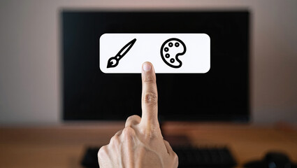 Digital Art Creation Interface on Computer Screen with Finger Pointing to Paintbrush and Palette Icons for Graphic Design and Creative Software Selection