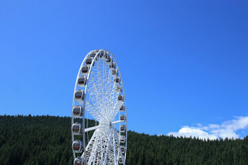 Close-up of amusement ride during a warm sunny day, perfect for travel, leisure and summer freedom themes.