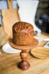 Traditional Easter cakes (kulich) with icing, dried fruits, and nuts on rustic background. Homemade sweet bread, festive pastry for Orthodox Easter, decorated with eggs and spring details.