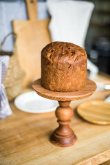 Traditional Easter cakes (kulich) with icing, dried fruits, and nuts on rustic background. Homemade sweet bread, festive pastry for Orthodox Easter, decorated with eggs and spring details.