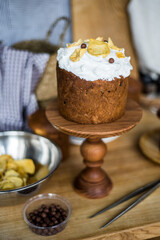 Traditional Easter cakes (kulich) with icing, dried fruits, and nuts on rustic background. Homemade sweet bread, festive pastry for Orthodox Easter, decorated with eggs and spring details.