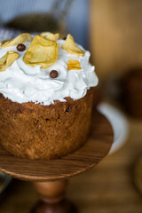 Traditional Easter cakes (kulich) with icing, dried fruits, and nuts on rustic background. Homemade sweet bread, festive pastry for Orthodox Easter, decorated with eggs and spring details.