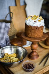 Traditional Easter cakes (kulich) with icing, dried fruits, and nuts on rustic background. Homemade sweet bread, festive pastry for Orthodox Easter, decorated with eggs and spring details.