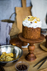 Traditional Easter cakes (kulich) with icing, dried fruits, and nuts on rustic background. Homemade sweet bread, festive pastry for Orthodox Easter, decorated with eggs and spring details.