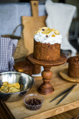 Traditional Easter cakes (kulich) with icing, dried fruits, and nuts on rustic background. Homemade sweet bread, festive pastry for Orthodox Easter, decorated with eggs and spring details.