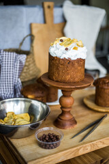 Traditional Easter cakes (kulich) with icing, dried fruits, and nuts on rustic background. Homemade sweet bread, festive pastry for Orthodox Easter, decorated with eggs and spring details.