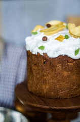 Traditional Easter cakes (kulich) with icing, dried fruits, and nuts on rustic background. Homemade sweet bread, festive pastry for Orthodox Easter, decorated with eggs and spring details.