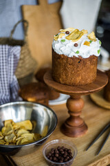 Traditional Easter cakes (kulich) with icing, dried fruits, and nuts on rustic background. Homemade sweet bread, festive pastry for Orthodox Easter, decorated with eggs and spring details.