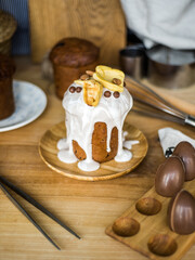 Traditional Easter cakes (kulich) with icing, dried fruits, and nuts on rustic background. Homemade sweet bread, festive pastry for Orthodox Easter, decorated with eggs and spring details.