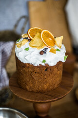 Traditional Easter cakes (kulich) with icing, dried fruits, and nuts on rustic background. Homemade sweet bread, festive pastry for Orthodox Easter, decorated with eggs and spring details.