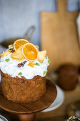 Traditional Easter cakes (kulich) with icing, dried fruits, and nuts on rustic background. Homemade sweet bread, festive pastry for Orthodox Easter, decorated with eggs and spring details.