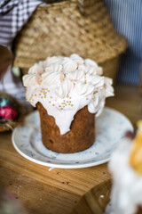Traditional Easter cakes (kulich) with icing, dried fruits, and nuts on rustic background. Homemade sweet bread, festive pastry for Orthodox Easter, decorated with eggs and spring details.