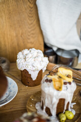 Traditional Easter cakes (kulich) with icing, dried fruits, and nuts on rustic background. Homemade sweet bread, festive pastry for Orthodox Easter, decorated with eggs and spring details.