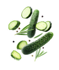 Fresh cucumbers, rosemary and peppercorns falling against white background