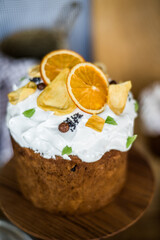 Traditional Easter cakes (kulich) with icing, dried fruits, and nuts on rustic background. Homemade sweet bread, festive pastry for Orthodox Easter, decorated with eggs and spring details.