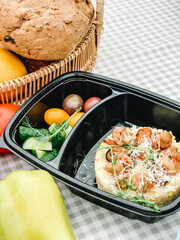 Healthy takeaway meals in lunch boxes with vegetables, fruits, and rice. Outdoor picnic, eating in car, casual food to-go, fitness meals, eco packaging, lifestyle food photography.