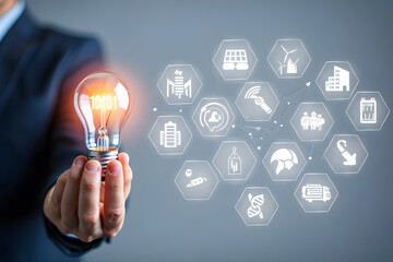 Innovative Solutions A Businessman Holds A Lightbulb Filled With Binary Code Surrounded By Hexagonal Icons Representing Sustainable Technologies And Eco Friendly Initiatives