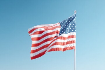 Obraz premium Waving flag against clear blue sky, symbolizing patriotism and u