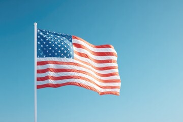 Obraz premium Waving flag showcases vibrant colors against clear blue sky, sym