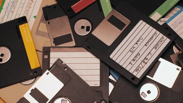 Floppy disc FDD close up, Using diskette for old PC computer macro. Archive programme or Music recorder, playing retro computer games. Vintage device for office, obsolete technology. 