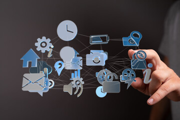 Hand interacts with a digital network of icons representing data, technology, and connection.