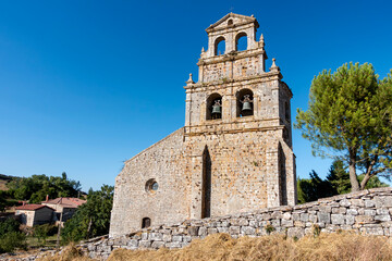 Fototapeta premium Historic church of Our Lady of the Assumption with its baroque belfry in Masa, Burgos, Spain