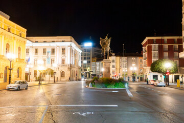 Obraz premium Urban cityscape of Burgos at night with illuminated historic buildings, Spain.